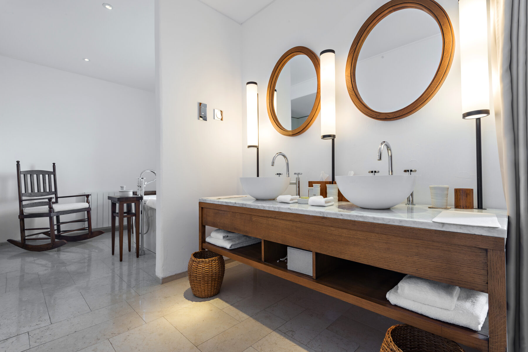 A calm bathroom with a freestanding tub and stone tiling